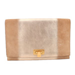 Tan foldover clutch with gold-tone logo turn-lock clasp.