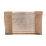 Tan foldover clutch with back panel seam and folded flap.