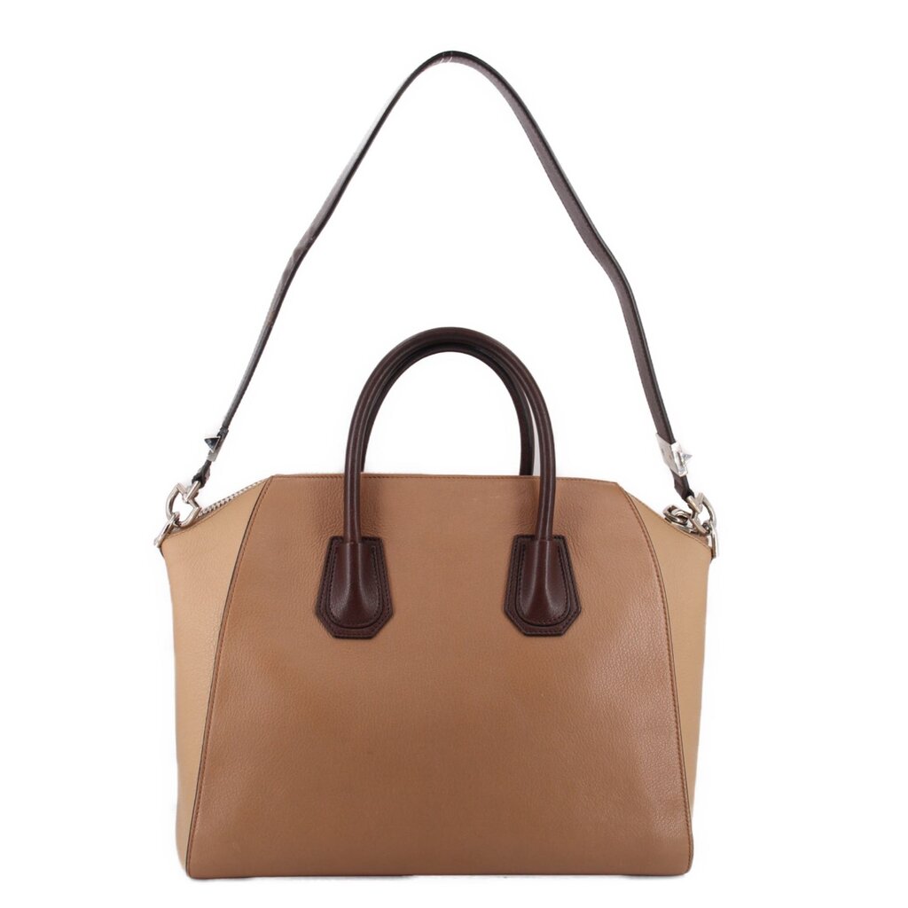 Brown leather tote bag with top handles, structured body, and side pockets