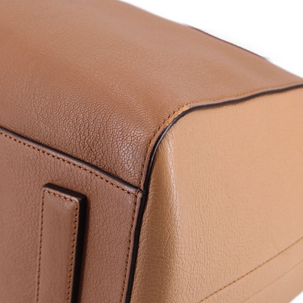Brown leather tote bag corner with top edge and stitch detail