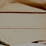 Brown leather bag interior lining with smooth base and seam stitching