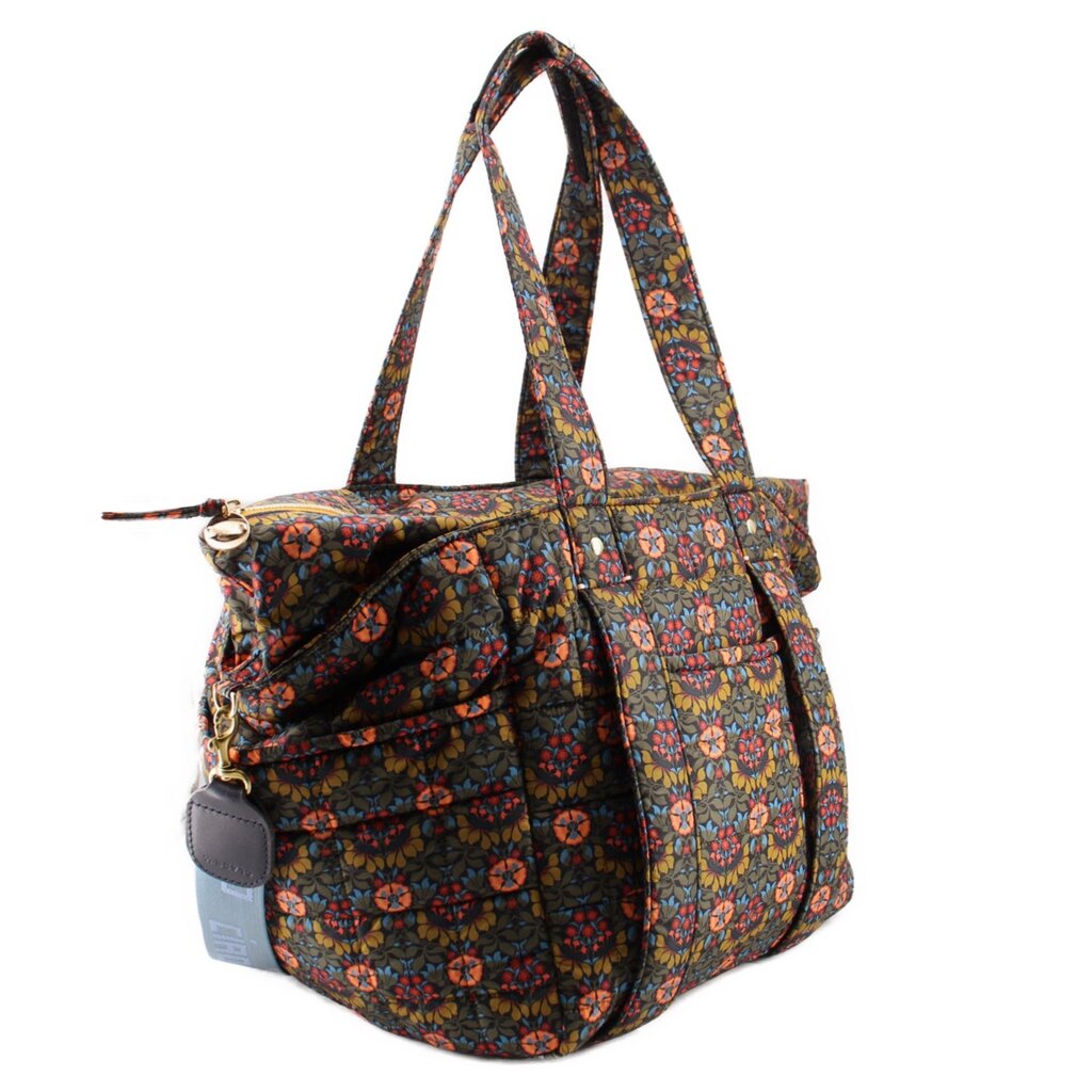 Floral quilted tote bag with side pocket flap and adjustable crossbody strap