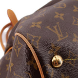 LOUIS VUITTON Tivoli GM monogram bag close-up of leather corner and gold-tone button