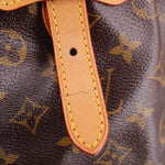 LOUIS VUITTON Tivoli GM monogram bag close-up of leather strap and yellow stitching