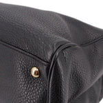 Black pebbled-leather tote corner with gold snap and stitched trim