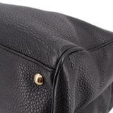 Black pebbled-leather tote corner with gold snap and stitched trim