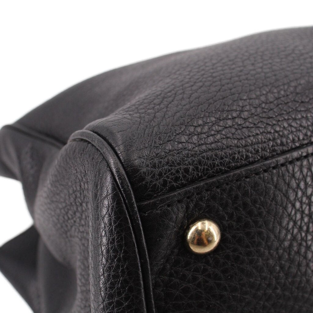 Black pebbled-leather handle end with gold snap detail