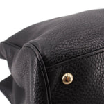 Black pebbled-leather handle end with gold snap detail