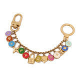 Gold chain keychain with multicolor enamel charms, including locks and hearts