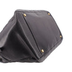 CHANEL grand shopper tote bag angled close-up showing dark leather trim and gold studs