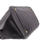 CHANEL grand shopper tote bag angled close-up showing dark leather trim and gold studs