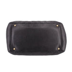 CHANEL grand shopper tote bag bottom view with gold corner studs on dark leather