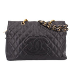 CHANEL grand shopper tote bag in dark quilted leather with gold chain handles and logo