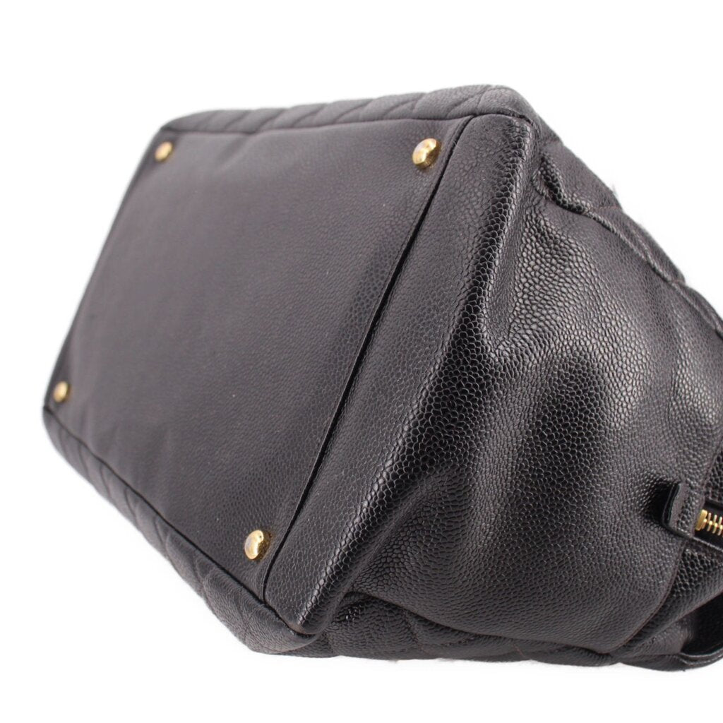 CHANEL grand shopper tote bag corner close-up with dark leather panels and gold studs