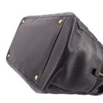 CHANEL grand shopper tote bag corner close-up with dark leather panels and gold studs