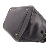 CHANEL grand shopper tote bag corner close-up with dark leather panels and gold studs