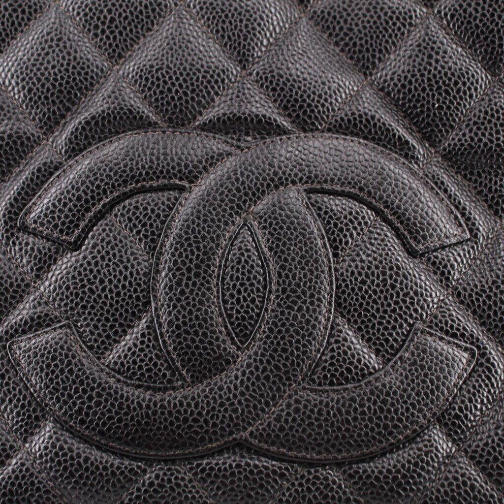 CHANEL embossed CC logo detail on dark quilted leather panel