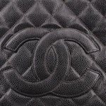 CHANEL embossed CC logo detail on dark quilted leather panel