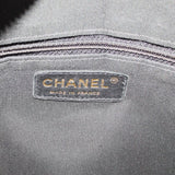 CHANEL tote interior label reading CHANEL and Made in France on gray fabric