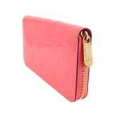 Coral patent leather zip wallet with gold-tone hardware on side flap