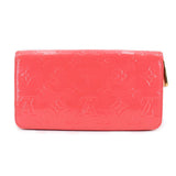 Coral vernis zip wallet with gold zipper pull and embossed logo panel