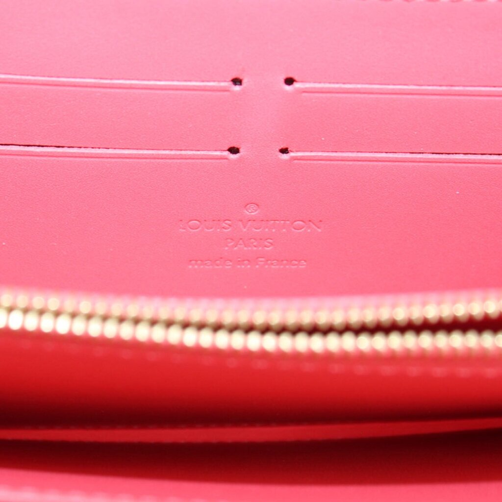 Coral interior lining with Louis Vuitton Paris stamp and zip track detail