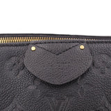 Black monogram bag close-up with curved front pouch, gold snap details, and zipper top.