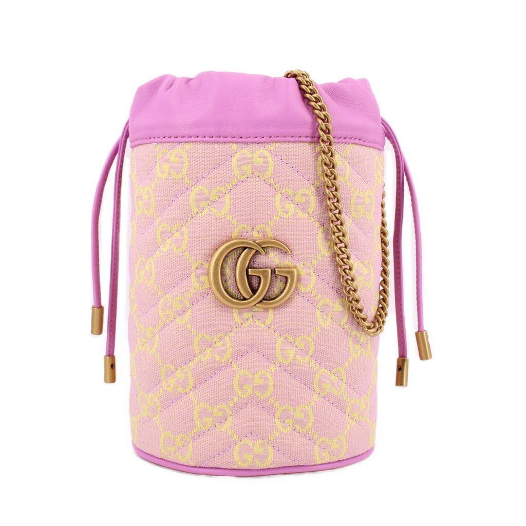 Pink mini bucket crossbody with GG monogram print, gold G emblem, and braided chain strap.
