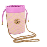 Pink mini bucket crossbody with GG monogram print, gold chain strap, and pink drawcords.