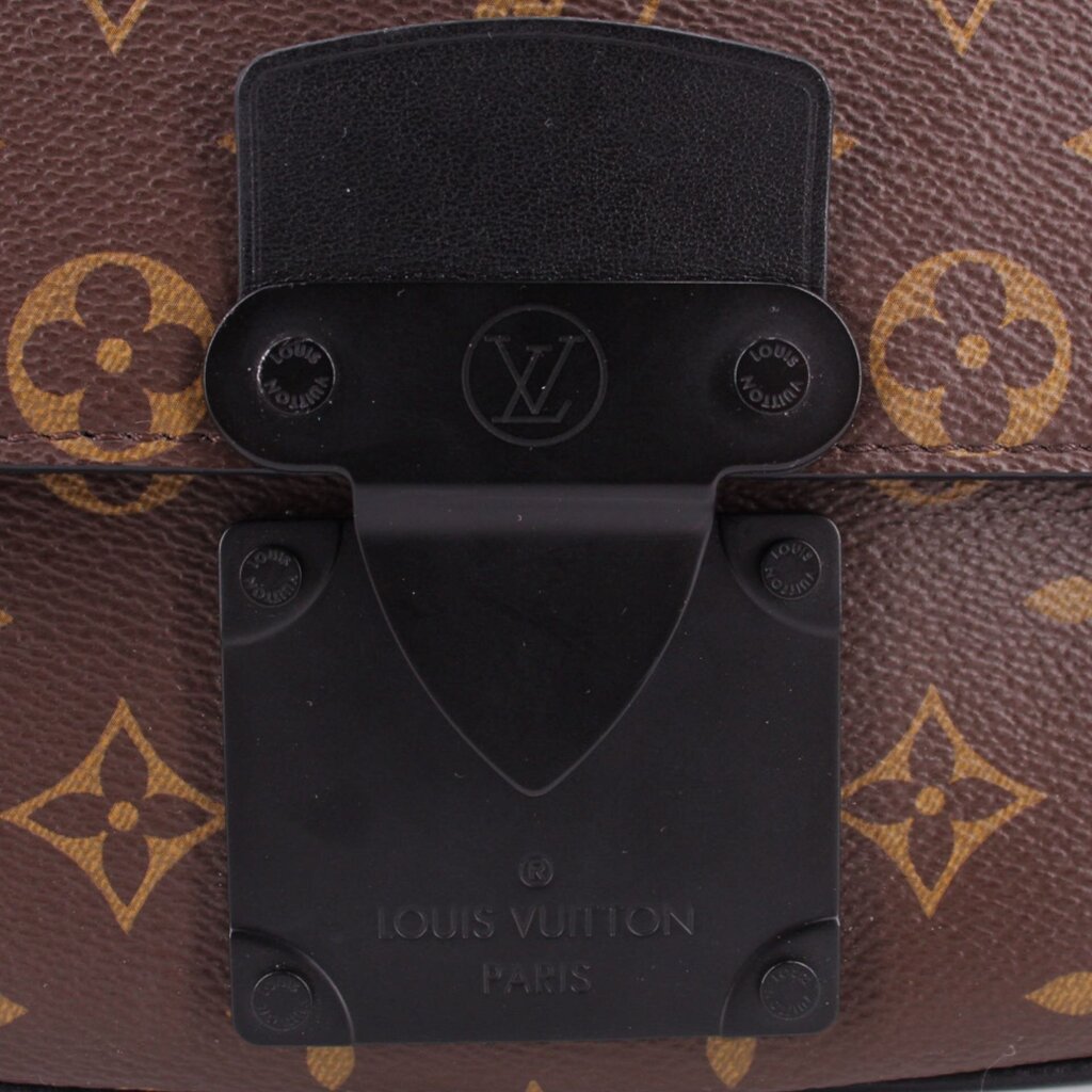 Black front lock plate on monogram sling belt bag with LOUIS VUITTON engraving