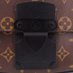 Black front lock plate on monogram sling belt bag with LOUIS VUITTON engraving