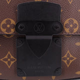 Black front lock plate on monogram sling belt bag with LOUIS VUITTON engraving