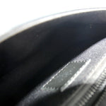 Monogram sling belt bag interior lining close-up in dark fabric