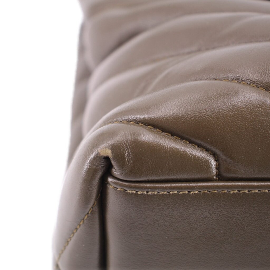 YSL puffer shoulder bag close-up: olive stitched leather seam and edge
