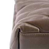 YSL puffer shoulder bag close-up: olive stitched leather seam and edge