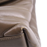 YSL puffer shoulder bag close-up: olive corner flap stitching and grain texture