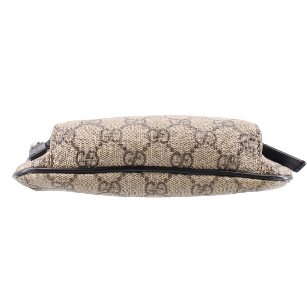 GUCCI belt bag side profile in tan GG canvas with black edge trim and strap