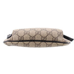 GUCCI belt bag side profile in tan GG canvas with black edge trim and strap