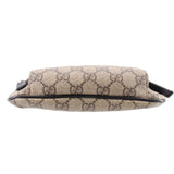 GUCCI belt bag side profile in tan GG canvas with black edge trim and strap