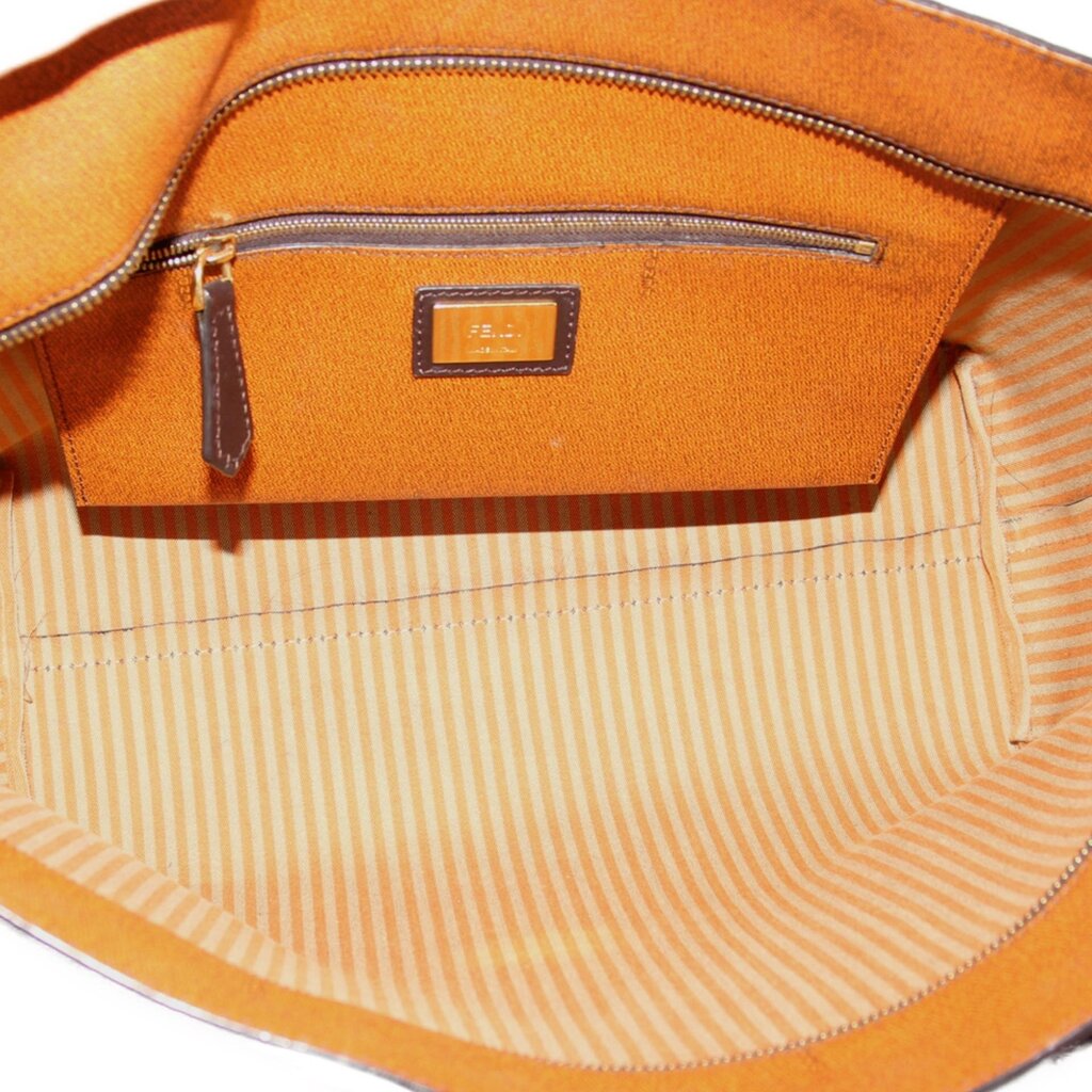 Tobacco Zucca roll tote interior with tan striped lining and front zip pocket.