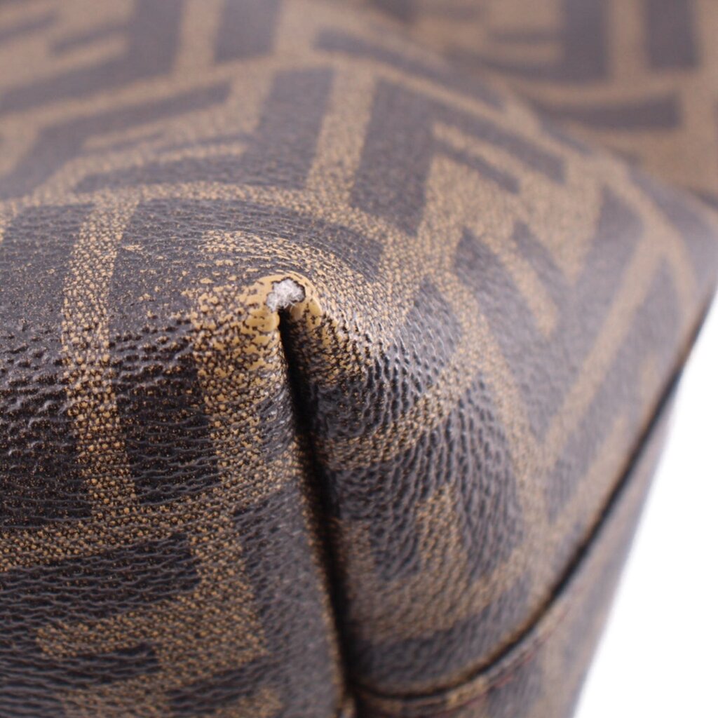 Tobacco Zucca FF monogram canvas corner with brown leather trim close-up.