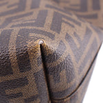 Tobacco Zucca FF monogram canvas corner with brown leather trim close-up.