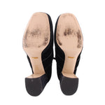 Bottom view of black suede ankle boots with flat soles