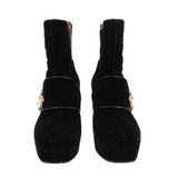 Pair of black suede ankle boots with front bee buckle and chunky heel