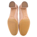 Nude leather heeled pumps with visible sole underside