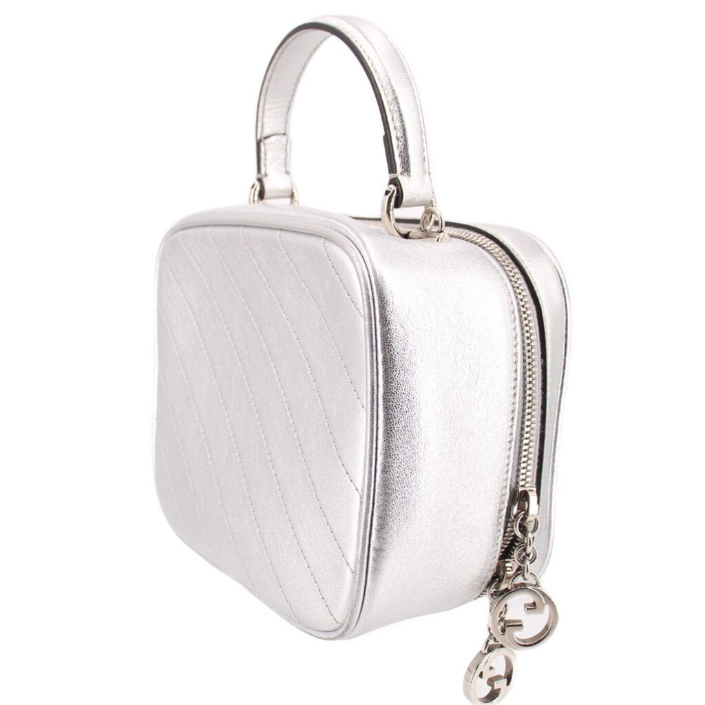 Gucci silver mini top-handle crossbody bag, angled side view with stitched panels