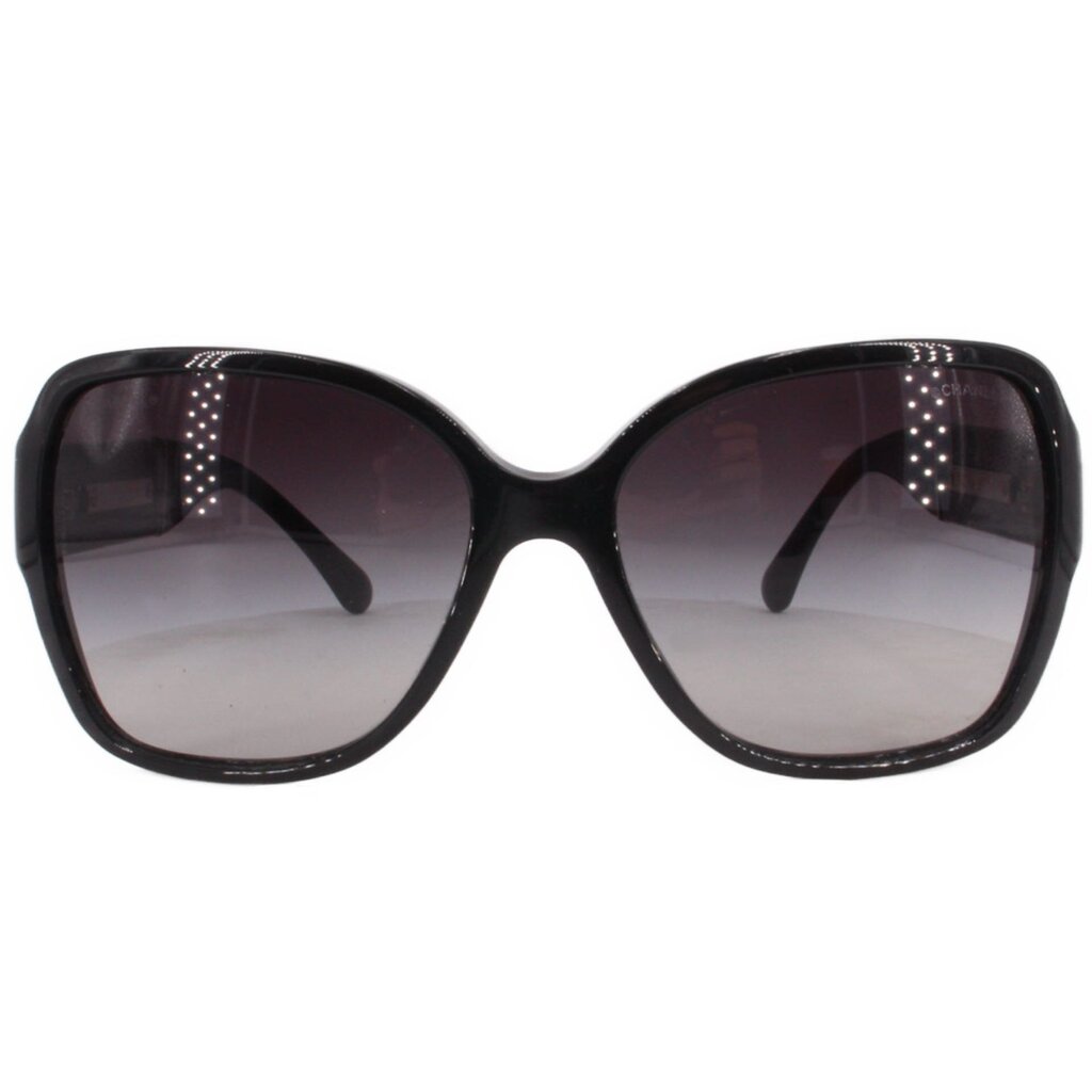 Black oversized square sunglasses with dark lenses and white CHANEL logo at center.