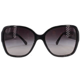 Black oversized square sunglasses with dark lenses and white CHANEL logo at center.
