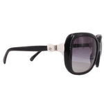 Black sunglasses with dark lenses, slim arms, and white CHANEL logo detail.
