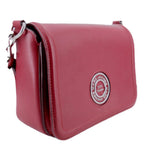 Maroon flap crossbody bag with round MARC JACOBS emblem, side view, metal trim